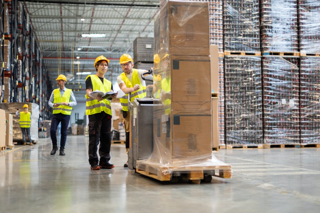 Logistics employees coordinating work in a warehouse